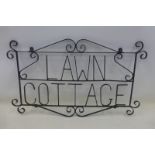 A wrought iron house name plate for Lawn Cottage, 30 1/2 x 18".