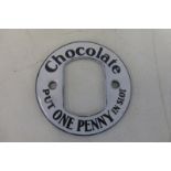 A Chocolate 'One Penny in Slot' circular enamel vending machine inscription, in mint condition, 2