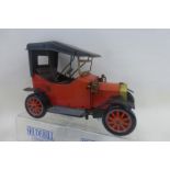 A tinplate model of an Edwardian motorcar.