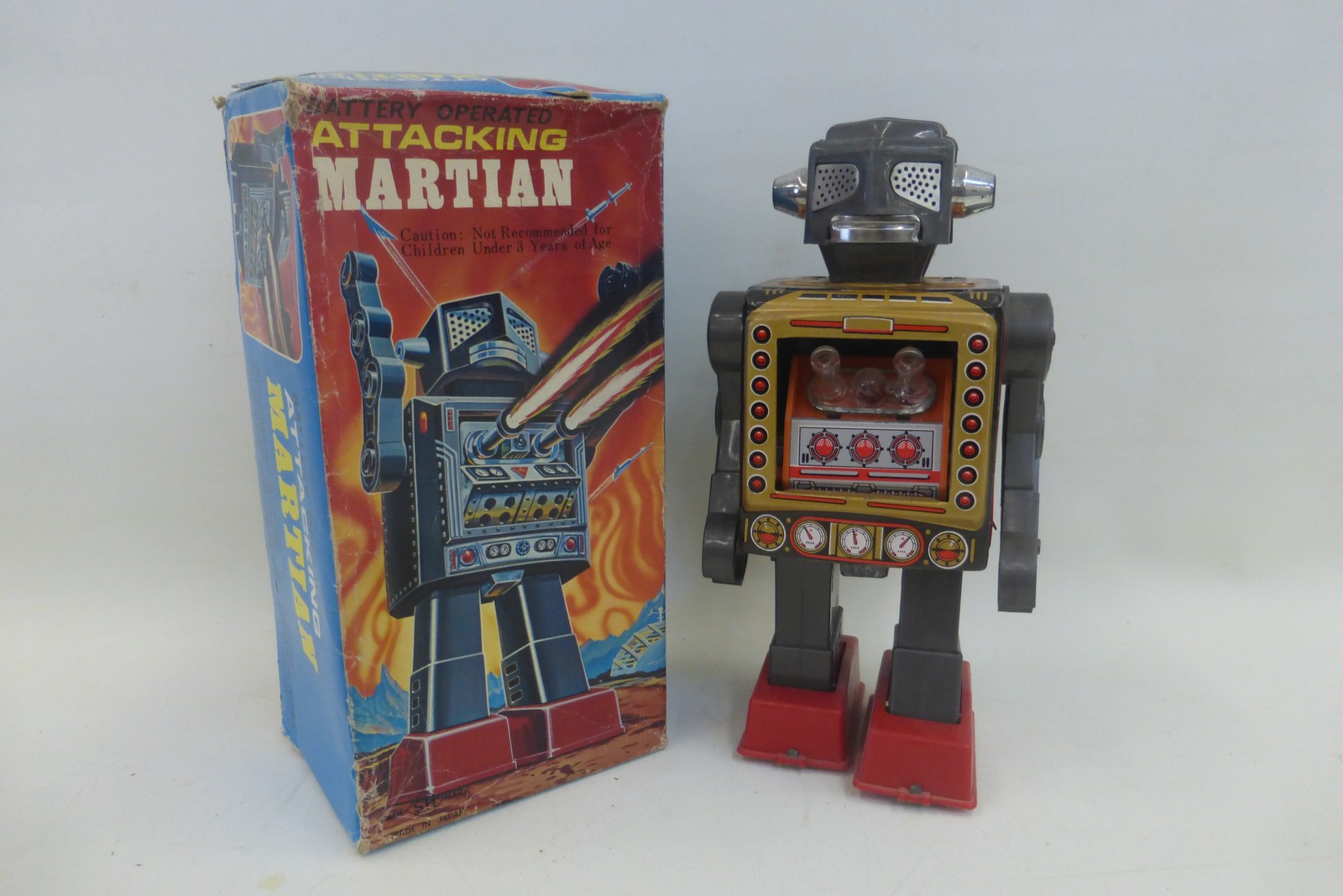 A boxed Japanese tinplate battery operated Attacking Marsian Robot made by Horikawa.
