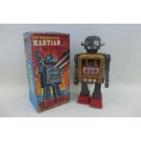 A boxed Japanese tinplate battery operated Attacking Marsian Robot made by Horikawa.