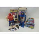 A selection of assorted toy robots, tinplate rockets etc.