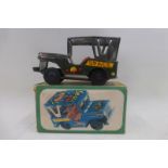 A boxed friction powered tinplate model of a Jeep.