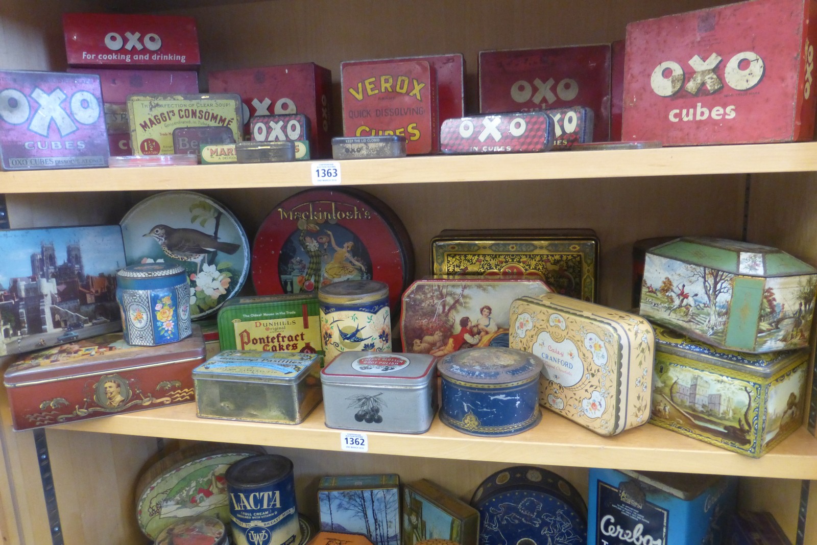 A shelf full of assorted tins including Mackintosh's.
