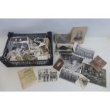 A tray of assorted photographs and postcards including military.