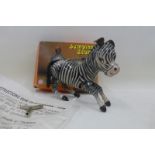 A boxed Chinese tinplate jumping zebra.
