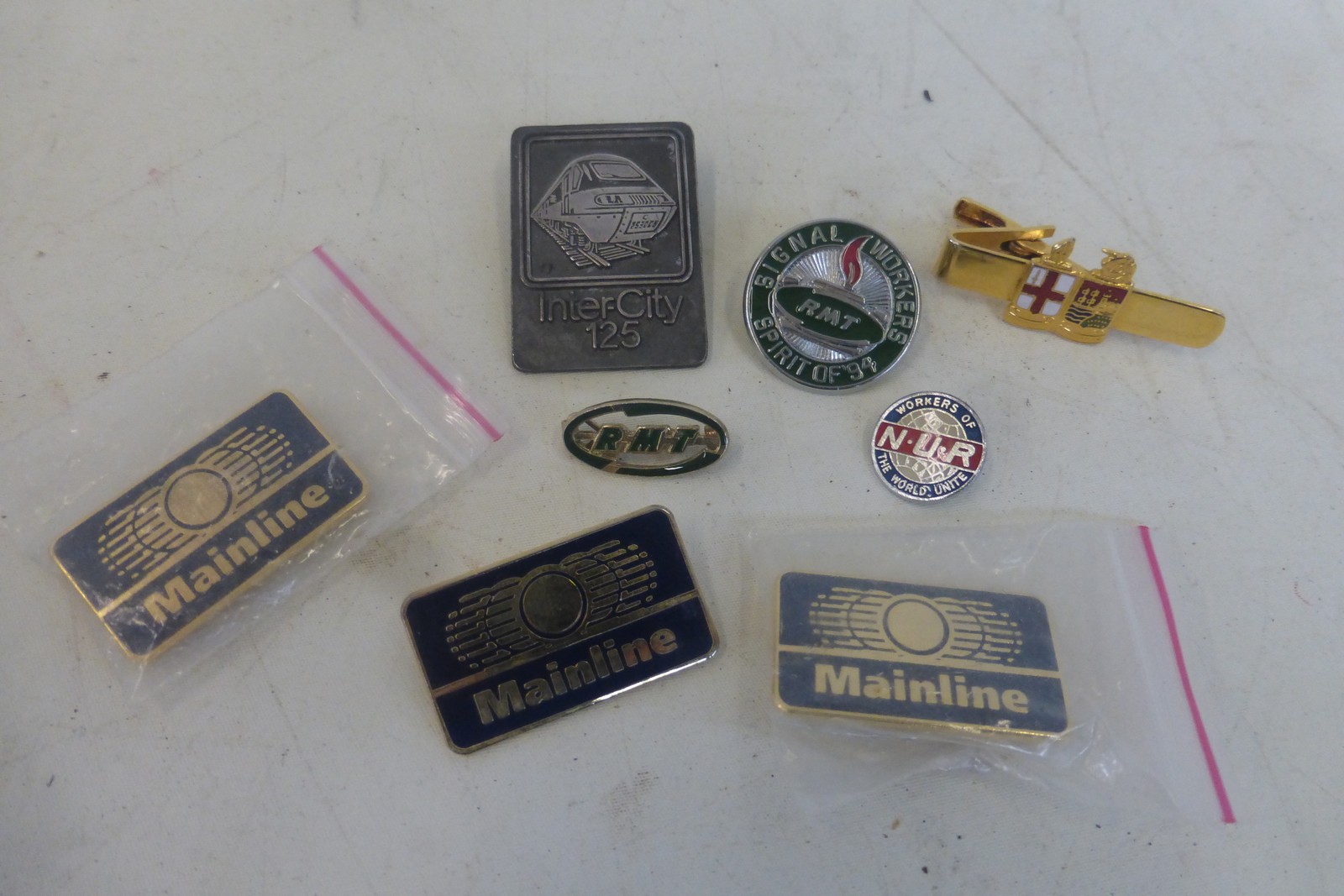 A collection of eight railway badges including three Mainline and an Inter-City 125 badge issued
