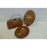 A pair of oval hardwood and marquetry inlaid panels and also a crocodile leather covered handbag.