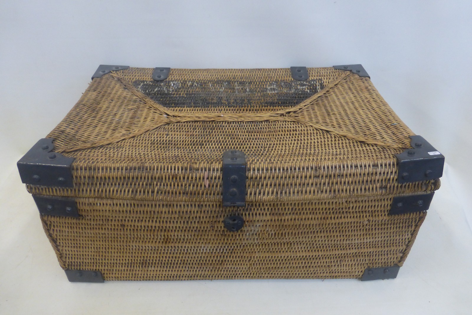 An unusual metal bound wicker trunk.