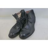 A pair of black leather lace-up shoes F.H & U's RUPERT, with tan leather soles.