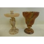 An alabaster candle holder, the stem formed by two storks, and another vase of wrythen form.