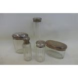 Five silver topped glass scent bottles.