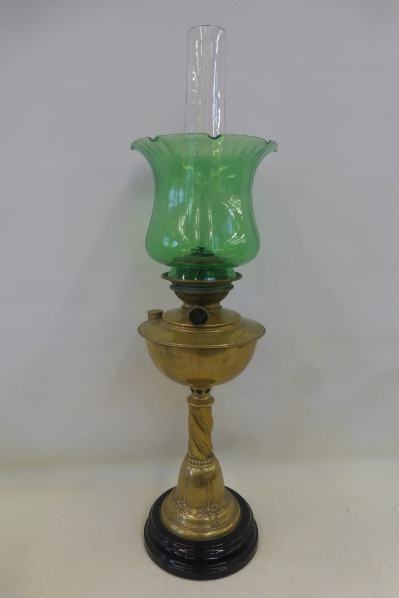 A good quality Victorian brass oil lamp with a green glass shade.