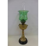 A good quality Victorian brass oil lamp with a green glass shade.