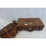 An early 20th Century brown leather suitcase and a brown leather holdall.