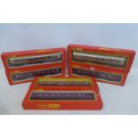 Three boxed Hornby Railways OO gauge carriages in LMS livery and three others in LNER livery.