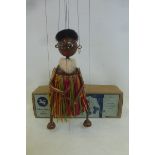 A boxed Pelham Puppet: Mumbo, mid 1950s, with brass rings on feet, original raffia, original