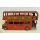 A Tri-ang tinplate double decker London Transport bus with Tri-ang Railways and Pedigree Pram