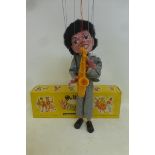 A boxed Pelham Puppet - Pop Singer no. 3, a saxophonist in striped outfit based on one of the