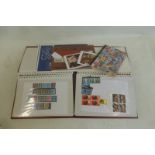 An album of mint GB stamps, various GB Defins. and Regionals, £5 books of stamps, also souvenirs.