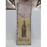 A Coca Cola pictorial partial tin advertising sign with central bottle motif, top trimmed, 18 x 54".