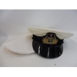 An officer's cap with rain cover, in original box of issue, possibly for a ship's captain.