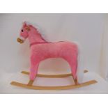 A pink rocking horse.