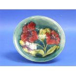A Walter Moorcroft 'Hibiscus' pattern Bowl, impressed marks, initialled in blue, 9?in (25cm)