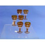 A set of six Bavarian amber-flashed Wine Glasses, each bowl engraved with fruiting vines and panel-