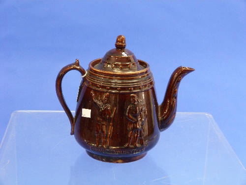 A Victorian treacle glazed Teapot, pear-shaped with acorn finial and scroll handle, moulded in - Image 2 of 2