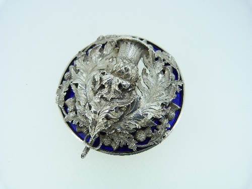 A large white metal and blue enamel Plaid Brooch, the open centre set with a large thistle and