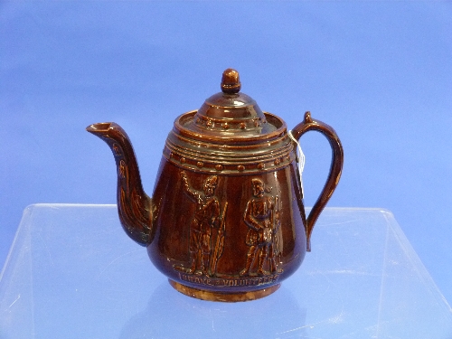 A Victorian treacle glazed Teapot, pear-shaped with acorn finial and scroll handle, moulded in