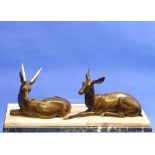 An Art Deco Bronze and Marble Centrepiece, modelled and cast as two deer, male and female, upon a