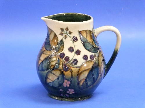 A Moorcroft pottery 'Blackberry' pattern Jug, impressed marks and painted initials, 7?in (20cm)