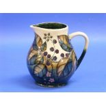 A Moorcroft pottery 'Blackberry' pattern Jug, impressed marks and painted initials, 7?in (20cm)