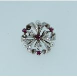 A similar brooch to above, in unmarked white metal, set with rubies and cultured pearls.