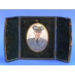 A portrait miniature of a young R.A.F. officer, possibly W.W.2 period, oval photographic portrait