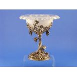 A silver plated Table Centrepiece, the circular foot with moulded scrolling vines, leaves and fruit,