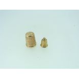 A 9ct rose gold Thimble, hallmarked Birmingham, 1919, together with a 9ct yellow gold thimble charm,