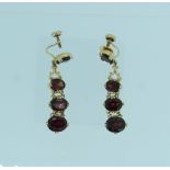 A pair of 14k yellow gold screw fitting pendant drop Earrings, formed of a single facetted garnet