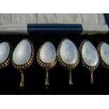 A cased set of six Norwegian silver gilt and enamel Teaspoons, by David Andersen, each with white