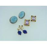A pair of 14k yellow gold Drop Earrings, the centres with blue carved stone, one damaged, together