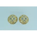 A pair of 14k yellow gold Clip Earrings, of large circular form, the fronts with textured and