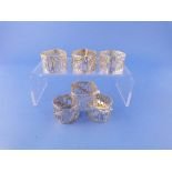 A set of six pierced silver Napkin Rings, marked 925, of square form with scrolling foliate