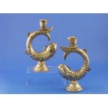 An associated pair of silver 'Fish' Candlesticks, each fish modelled in a circular form with tail