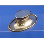 An oval silver Capstan Inkwell, marks very worn, 5½in (14cm) wide.