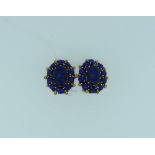 A pair of 14k yellow gold Clip Earrings, of oval form, with an outer circle of ten lapis beads