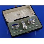 A cased George V silver three piece Cruet Set, hallmarked Birmingham, 1935, the mustard pot and open