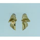 A pair of 14k yellow gold Clip Earrings, in the form of two textured leaves, approx total weight
