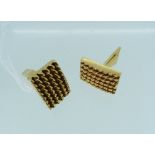 A pair of 14k yellow gold Cufflinks, the rectangular fronts with six rows of ropework, hinged bar